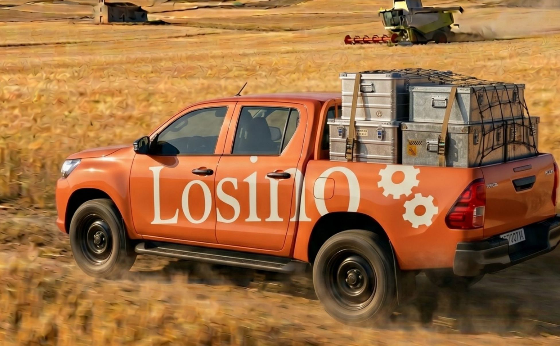Furgoneta naranja de Losino cruzando un campo de cereal